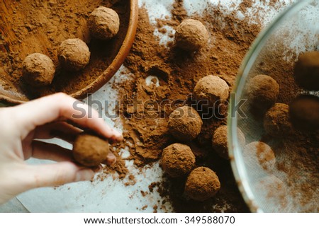 Hand holding a chocolate truffle