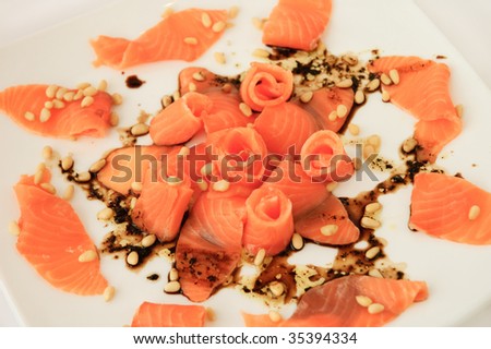 European cuisine - Salmon carpaccio with cedar nuts and balsamico sauce