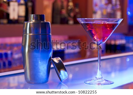 cocktail drink and shaker on a bar