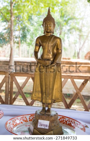 Attitude or Posture of the old golden Buddha in Thai Temple: Standing with alms bowl for Wednesday Day.