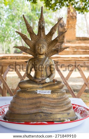 Attitude or Posture of the old golden Buddha in Thai Temple: Naga protection for Saturday.