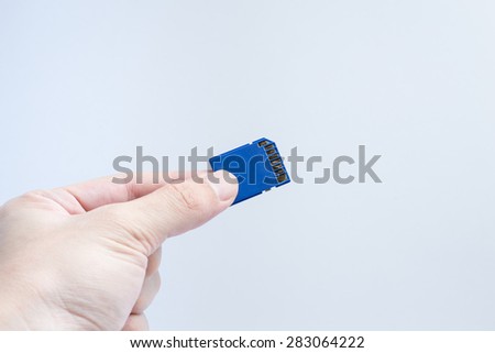 SD memory card with hand and finger hold isolate on white background.
