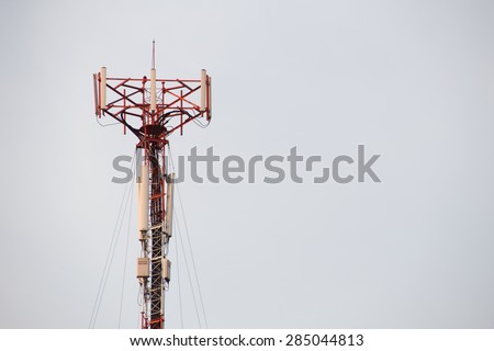 Cell site, Telecommunications radio tower or mobile phone base station with atop the antennas isolated with white sky background.