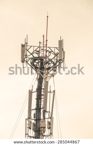 Cell site, Telecommunications radio tower or mobile phone base station with atop the antennas, vintage color tone.