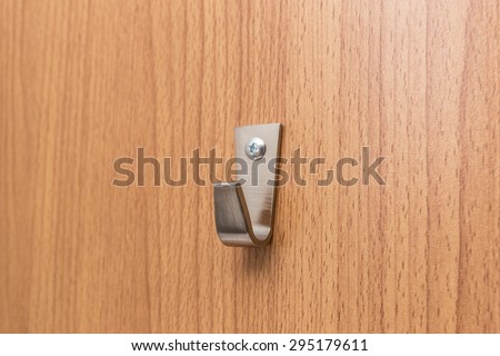 Steel Wall Hanger, Wall Hooks for coats or keys on wooden board background.