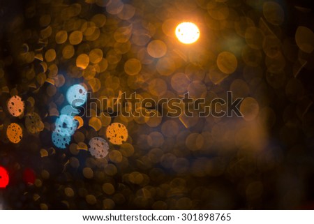 rain drop with street colorful traffic lights at night  blur bokeh abstract background vintage color tone, Cool chill wet raining season concept