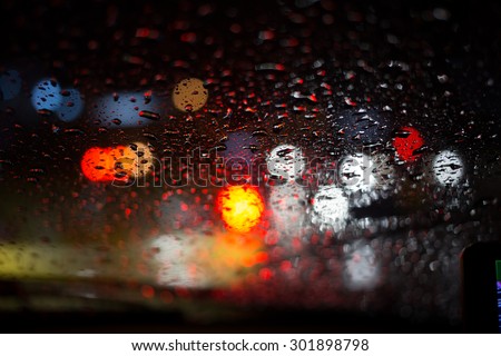 rain drop with street colorful traffic lights at night  blur bokeh abstract background vintage color tone, Cool chill wet raining season concept