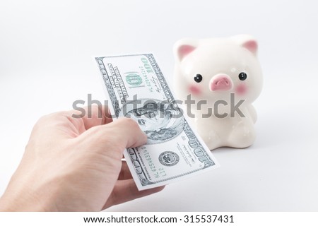 Hand pay money with piggy bank background,saving concept.