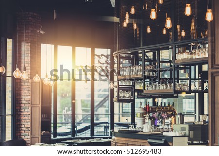 modern loft style restaurant decoration with hanging light bulb beer pub and bar.