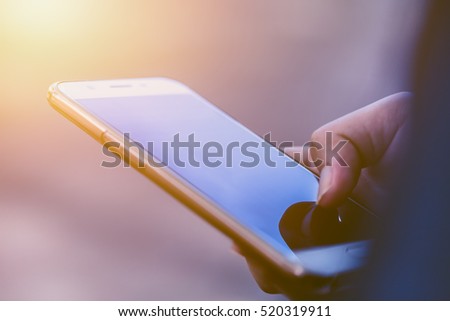 closeup hand hold using mobile phone or reading news from smartphone in the morning.