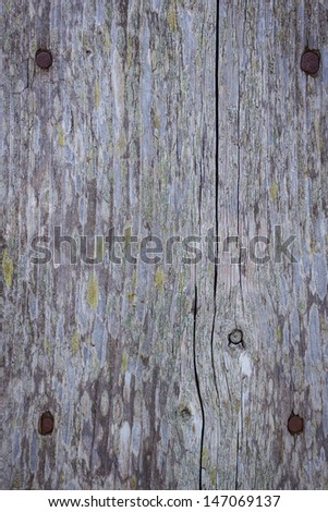 Background composed of planks of old wood and a four rusty nails