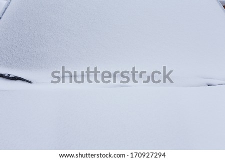Closeup of a car covered in snow