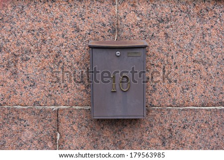 mail box on the red granite wall