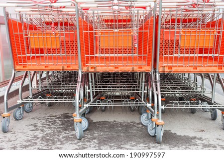 Shopping carts on a parking lot . Detail of a shopping cart