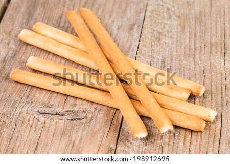bread sticks grissini on rustic wooden background