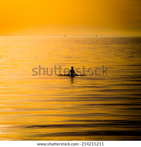 silhouette of ocean woman in sunset light