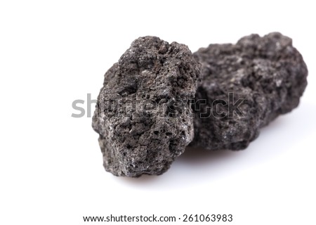 Black lava rock from Etna volcano on a white background
