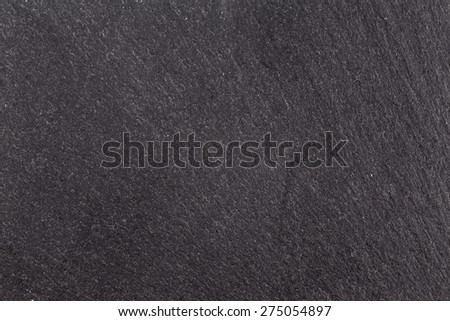 Dark gray granite texture or background with vignette