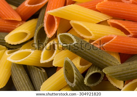 Color penne pasta. Tomato, spinach and wheat pastas in horizontal format