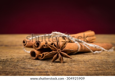 Close up of cinnamon sticks and star anise on rustic wood background