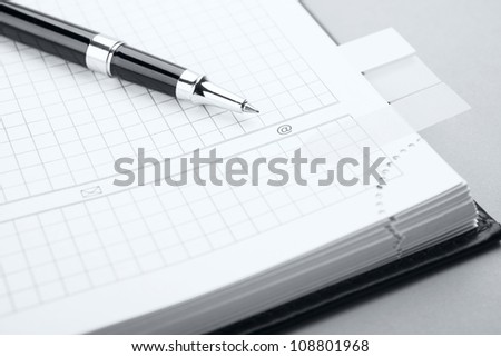 Clean sheet of notebook with a pen