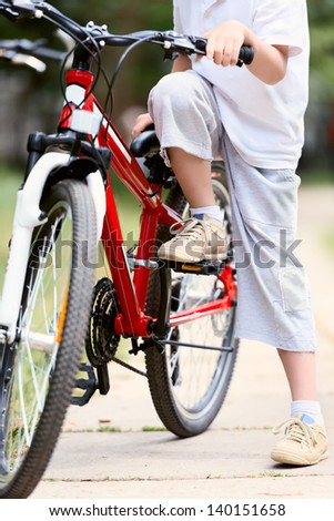 Child with bike in the town park