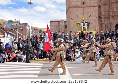 PUNO, PERU - MAY 19: Military unit marches on the main city square as it arrives at the parade on May 19, 2013 in Puno, Peru.