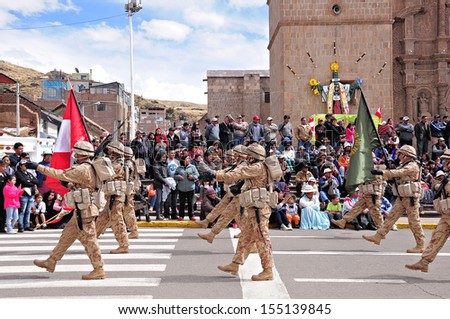 PUNO, PERU - MAY 19: Military unit marches on the main city square as it arrives at the parade on May 19, 2013 in Puno, Peru.