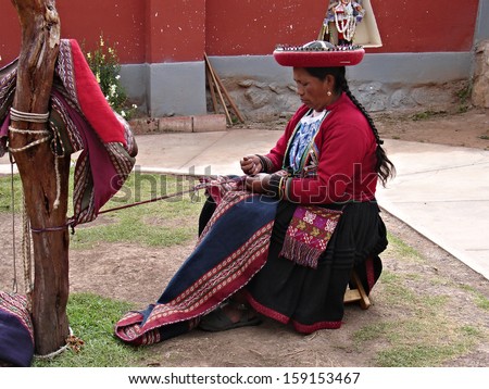 CHINCHERO, PERU - MAY 17: Woman shows process of making of the clothes from alpaca and llama wool on May 17, 2013 in Chinchero, Peru. Chinchero-settlement locates 58 km away from Cusco.