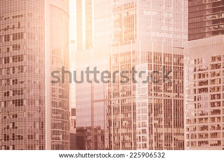 Walls of the buildings in the business city center at sunrise time.