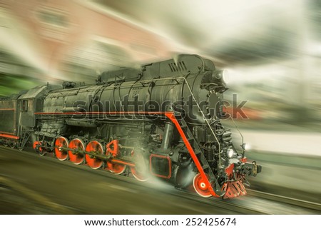 Steam train goes fast on the night station background. Vintage image.