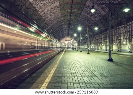 High speed train departs from the station at night time.