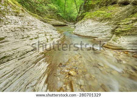 Creek with pure water in the deep canyon.