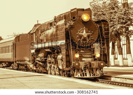 Vintage style of the retro steam train standing on the station.