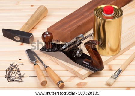 Carpentry tools on wooden background.