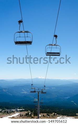 Chairlift running down Mount Hood with Mount Jefferson visible in the background