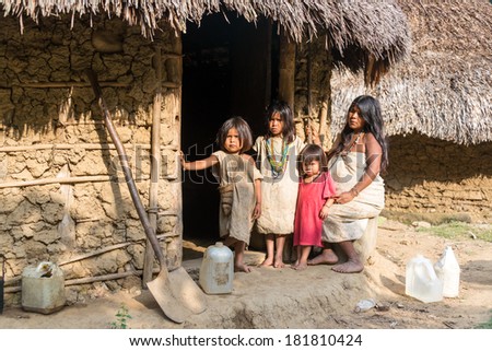 MAGDALENA, COLOMBIA - FEBRUARY 6: An indigenous Wiwa family stands in front of their house in the Magdalena Department in Colombia on February 6, 2014