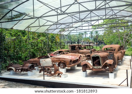 PUERTO TRIUNFO, COLOMBIA - FEBRUARY 26: A destroyed collection of cars that once belonged to Pablo Escobar on display in Puerto Triunfo, Colombia on February 26, 2014.