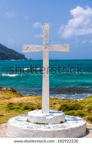 View of a white cross with the Caribbean Sea in the background at La Miel, Panama