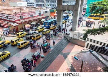 MEDELLIN, COLOMBIA - MARCH 6: Busy street scene with hat vendors and traffic in Medellin, Colombia on March 6, 2014