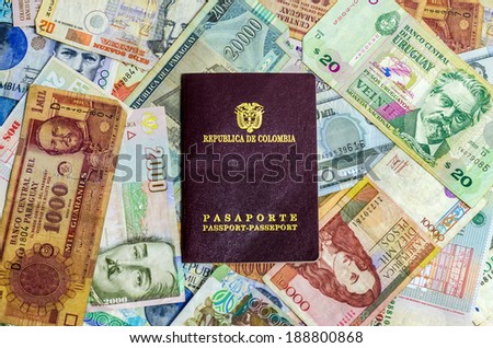 Colombian passport with various Latin American currencies