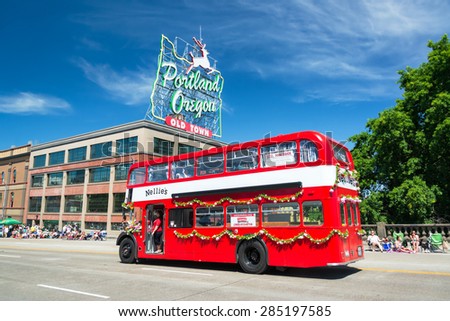 PORTLAND, OR - JUNE 6: Red double decker bus passes as part of the Grand Floral Parade on June 6, 2015 in Portland, Oregon