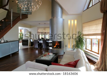 A modern living room interior with fireplace and leather couch