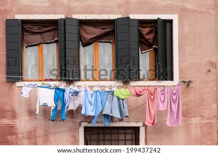Typical scenery with drying clothes on a clothesline on the island Burano close to Venice, Italy.