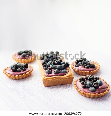 Delicious fruit tart made with blackberries and blueberries. Picture with copy space and shallow DOF.