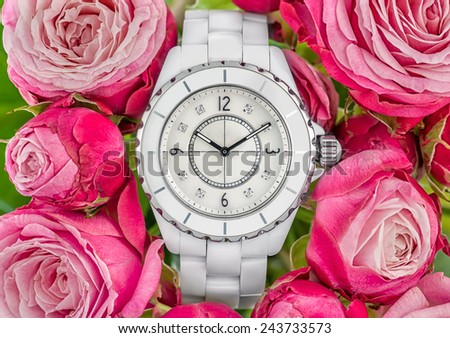 Luxury white woman watch on pink roses back ground