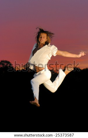 Man jumping for joy - sunset background