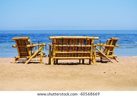 Bamboo chairs and sofa on the beach facing sea, provides a relax moment for holiday makers.