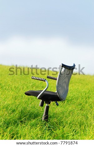 A office chair on green grass