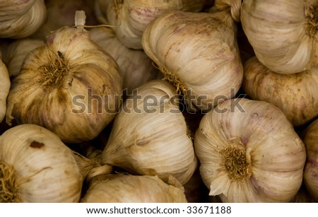 Fresh garlic, in bulk, on sale in a fresh produce market